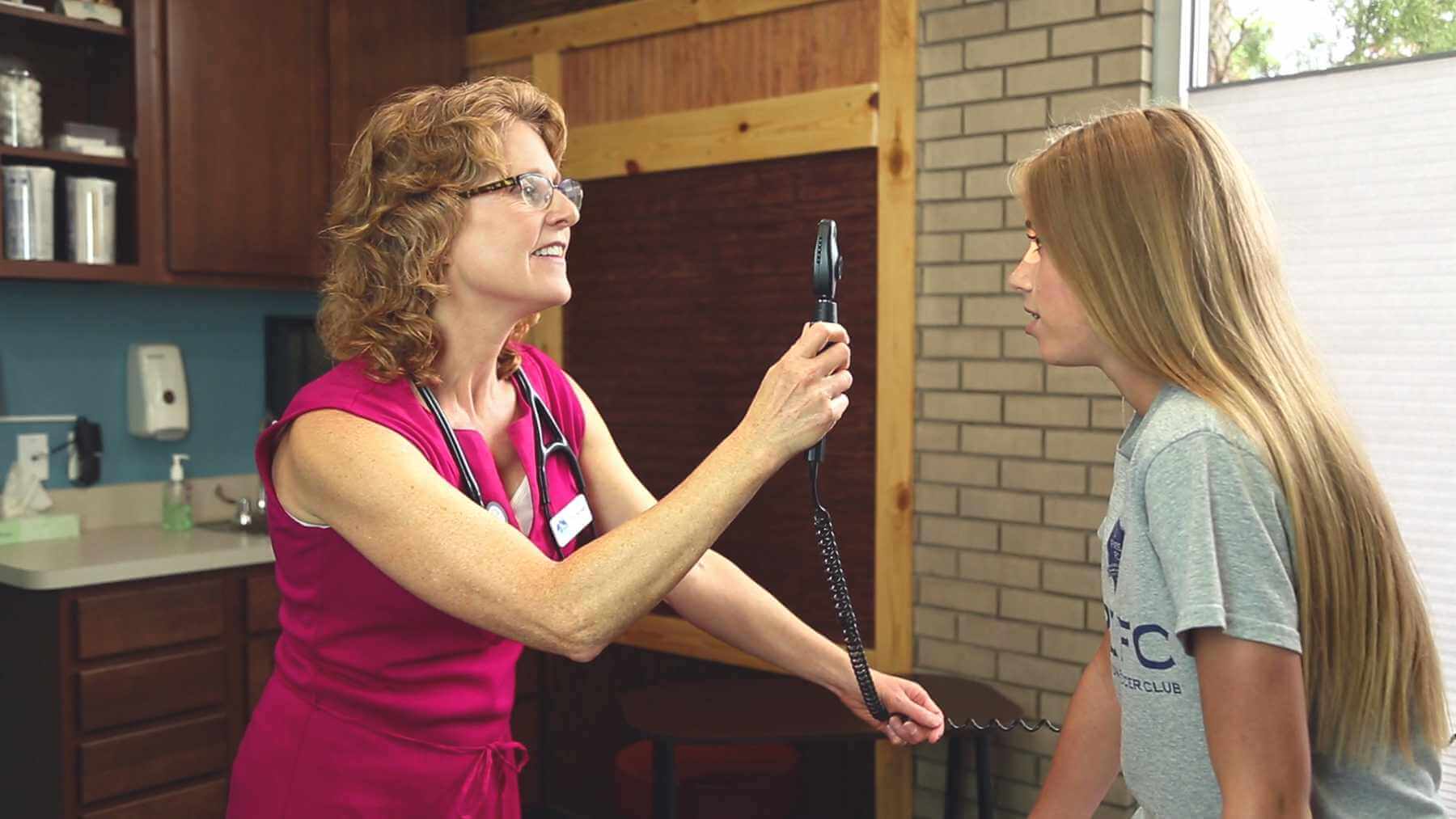 Trailhead-Clinics-Doctor-Looking-Into-Patients-Eye Family health medical clinic