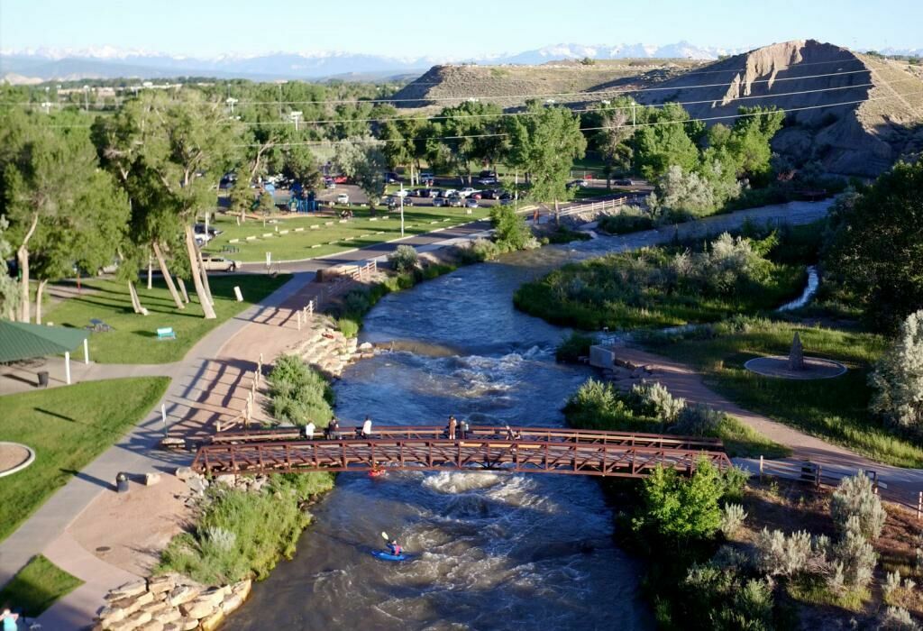 A bridge over a river with trees in the background